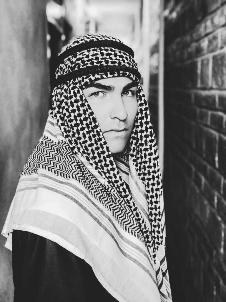 Stunning black and white portrait of a man wearing traditional Middle Eastern attire, exuding elegance and style.